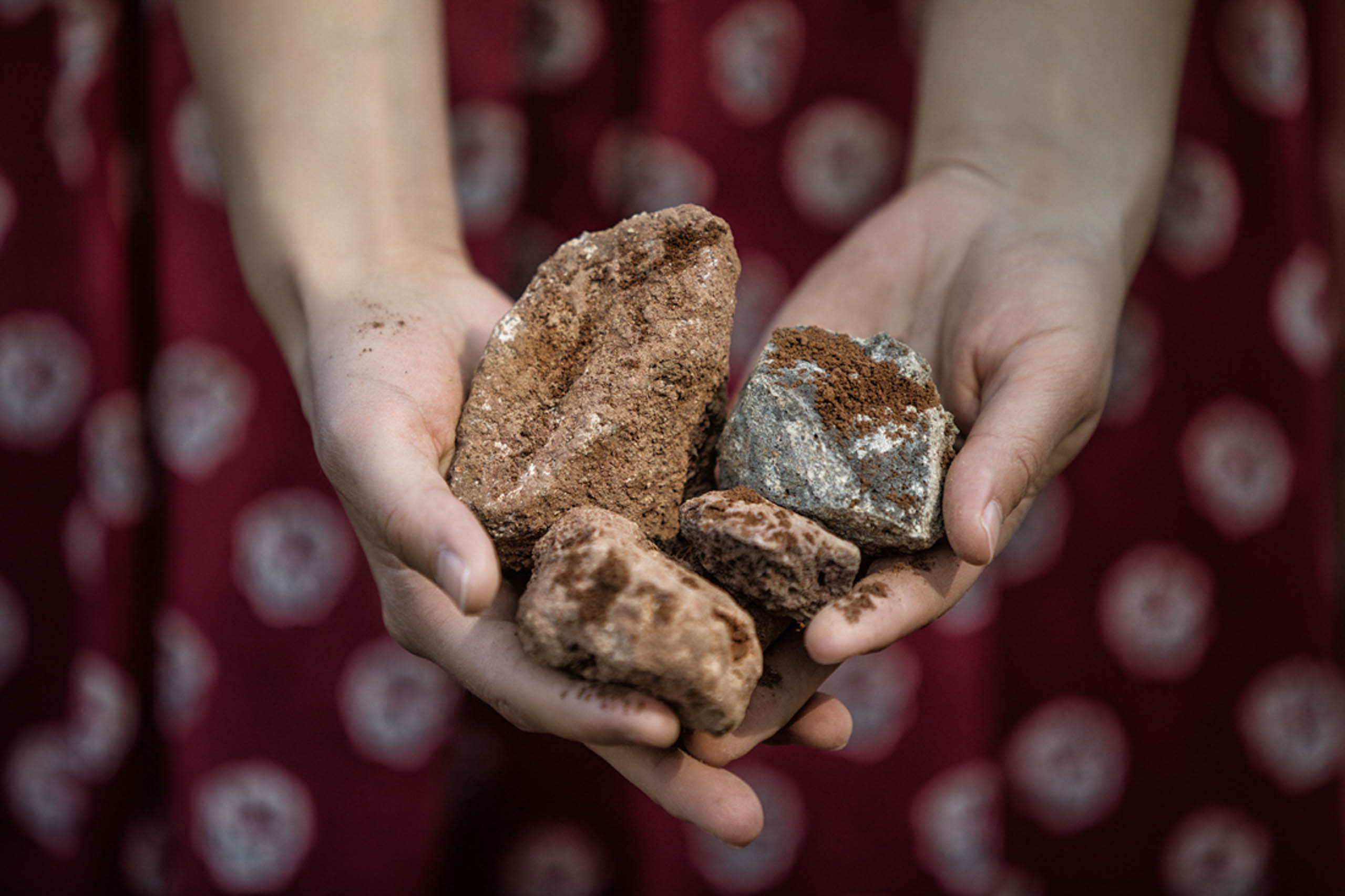 Zoom on someone's hands showing stones found in the Steiermark grounds